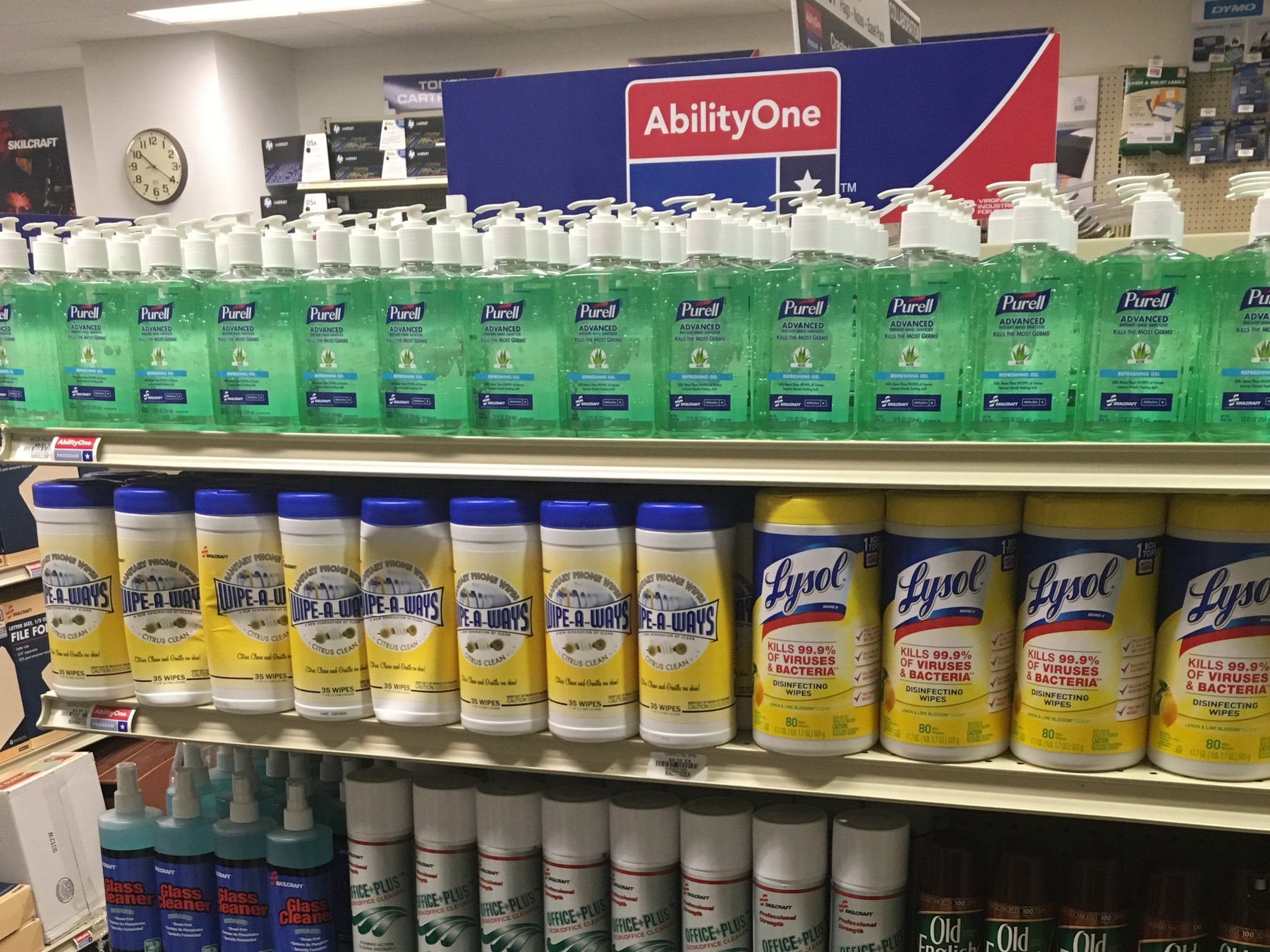 An aisle diplaying Purell anti-baterial gel and Lysol cleaning wipes